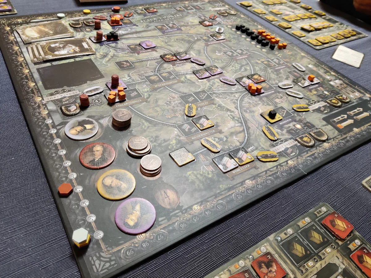 Brass: Birmingham mid-game: the dark canal-era board with industry tiles, coins and player mats