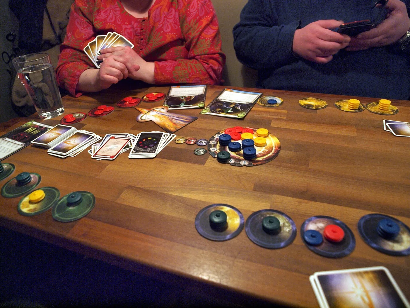 Cosmic Encounter in progress: planet discs with stacked plastic ships and the warp in the middle of the table