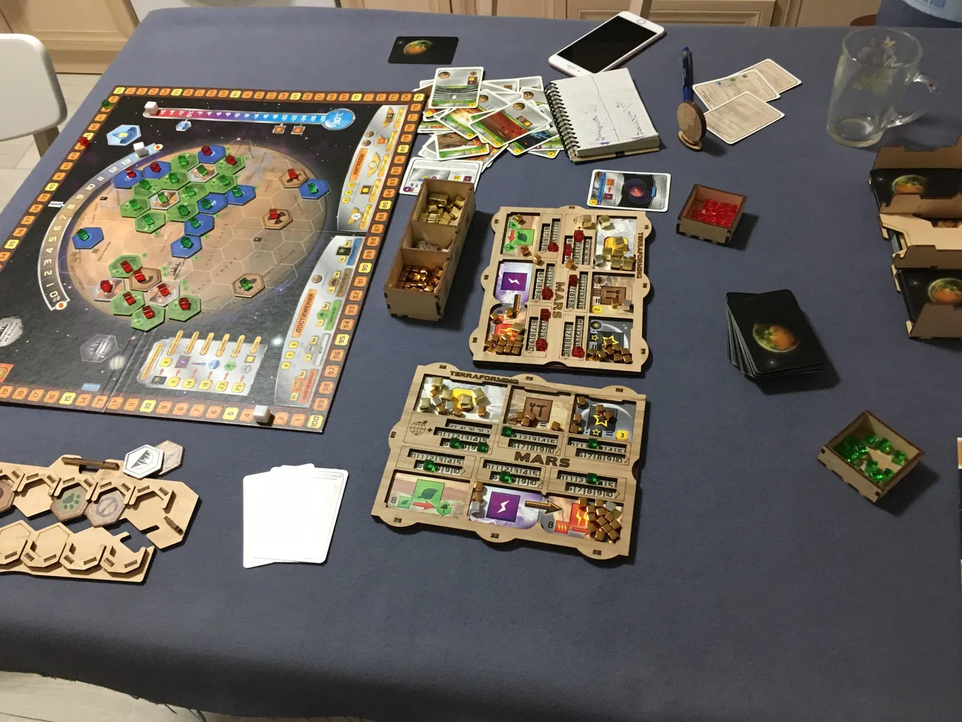 Our Terraforming Mars game in progress: the board, wooden organizer trays and player mats · 1