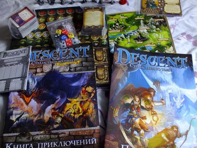 Descent campaign board and rulebooks spread out on the table · 2