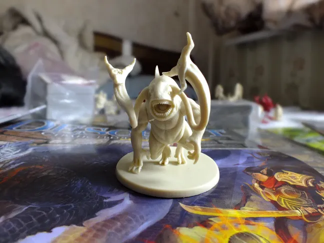 Descent miniatures lined up, with close-ups of the monster figures · 3